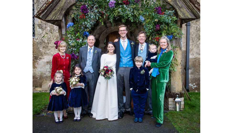 The bride, groom and a small selection of their friends and family outside their church.