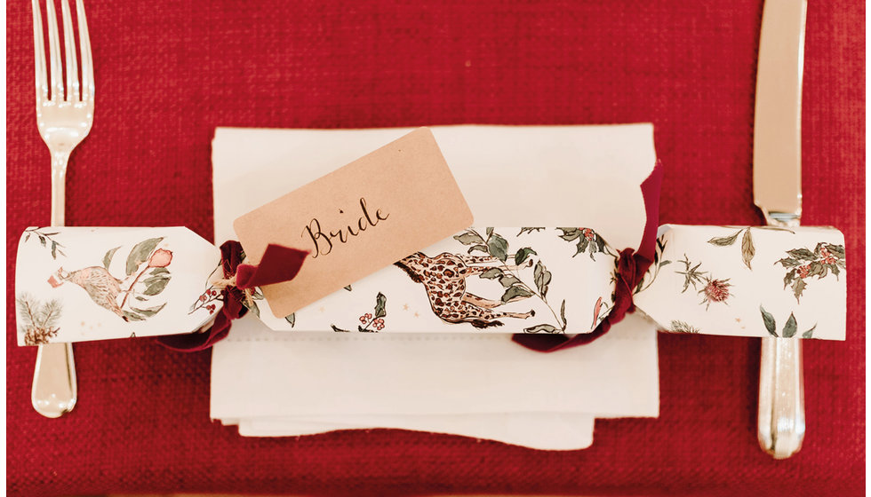 A cracker was laid one each place setting with each person's name in calligraphy.