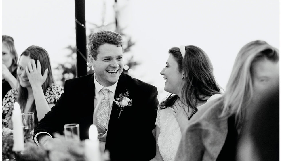 Fergus and Sarah laugh during the speeches in their stretch tent wedding reception.