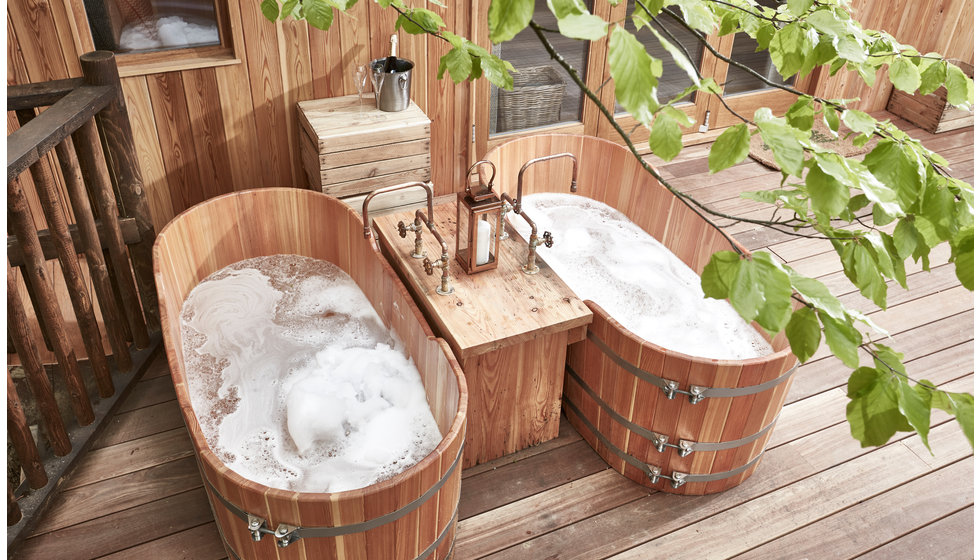 Two outdoor wooden baths in the treehouse outdoor bathroom at The Fish Hotel.