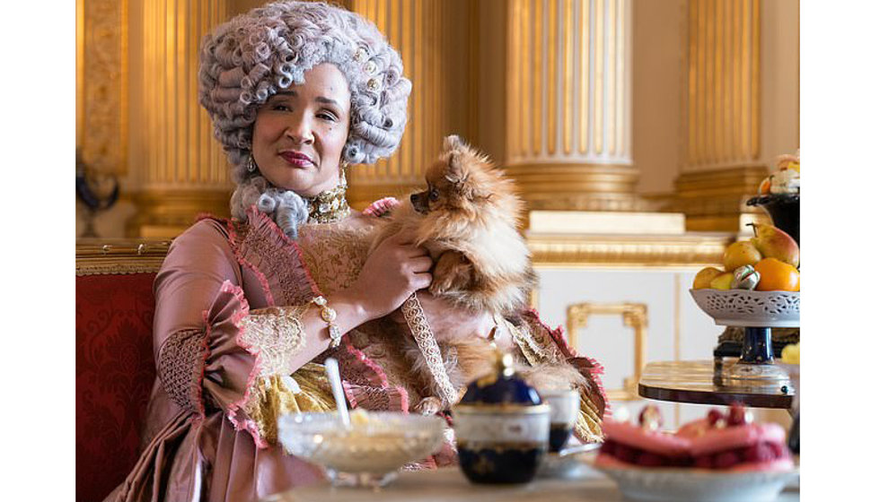The Queen and her dog having afternoon tea in the Netflix series Bridgerton.