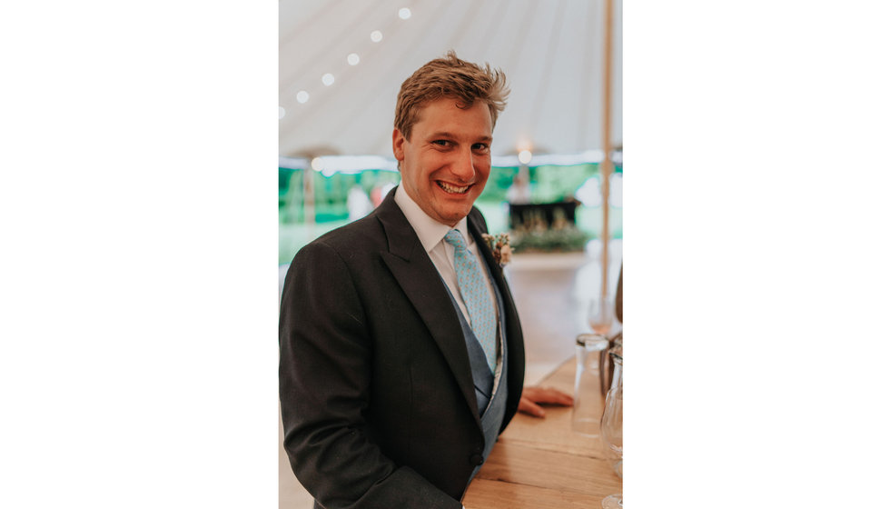 Real WPC Groom Ed wearing a morning suit and light blue tie on his wedding day in his marquee at his summer wedding.