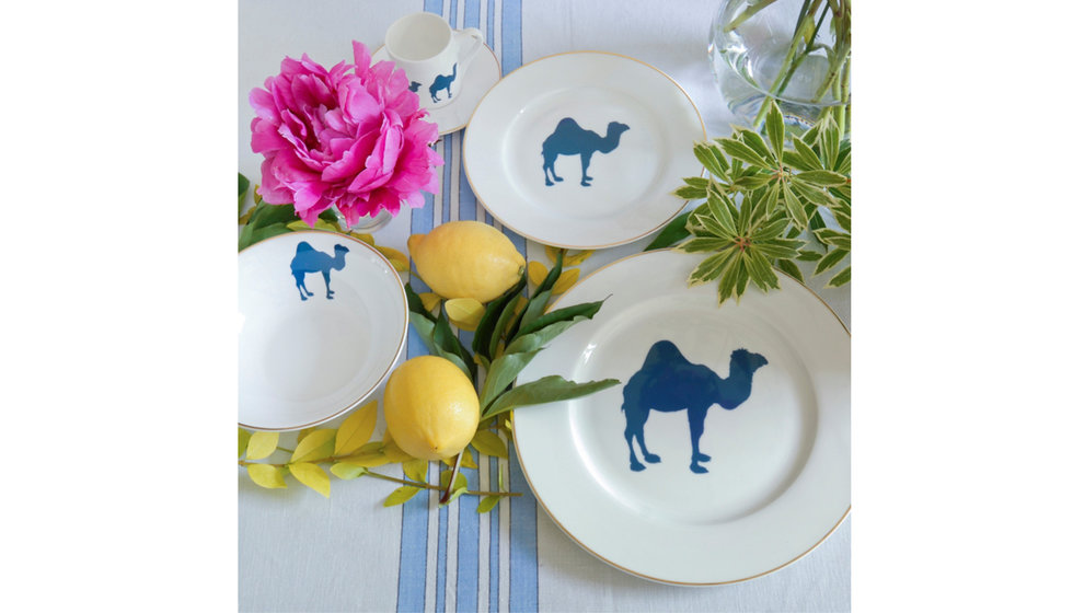 Alice Peto's camel dinner plates on a blue striped tablecloth with lemons and pink flowers.