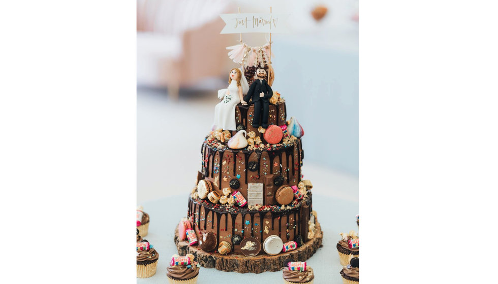 A Three Tier Chocolate cake decorated in sweets and chocolates. 