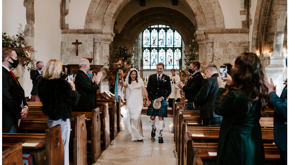 Sophie and Graeme walk down the aisle after their intimate wedding ceremony.
