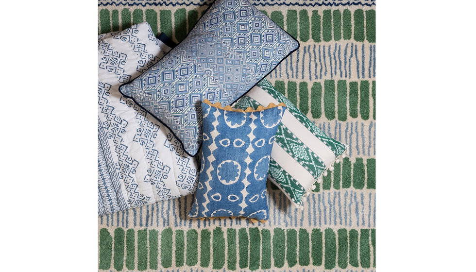 A pile of green and blue cushions. 