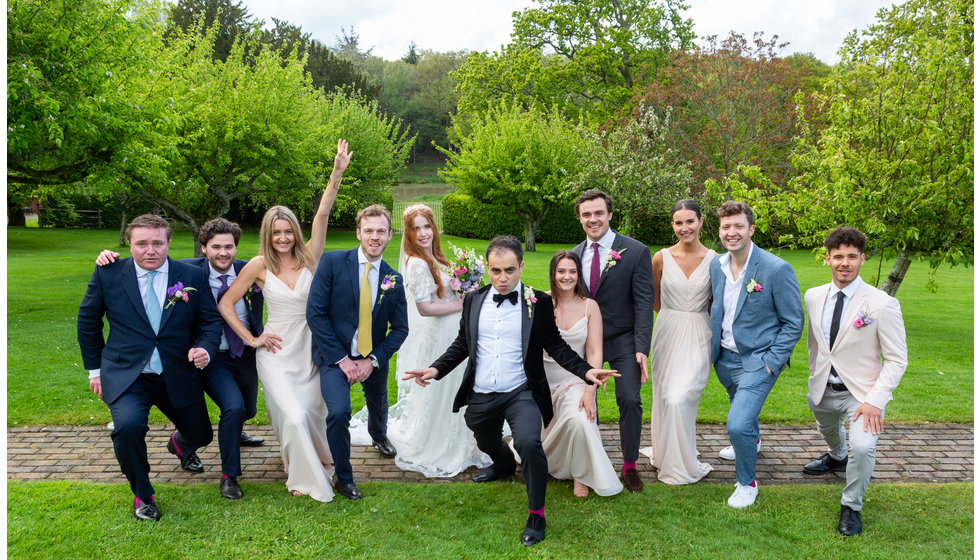 Sarah and Nico pose with their wedding guests for a silly photo.