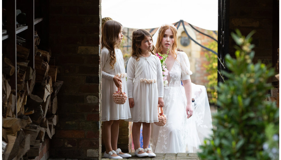 Sarah standing outside with two of her flower girls.