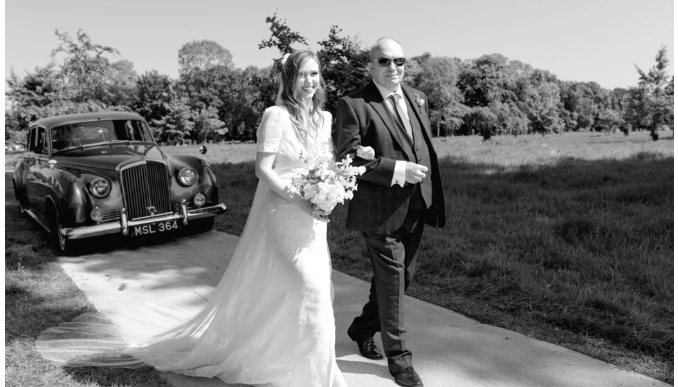 Charlotte & Harry's Magical Meadow Marquee Wedding in Oxfordshire: Bride in J Andreatta Wedding Dress, Walking Down the Wedding Aisle