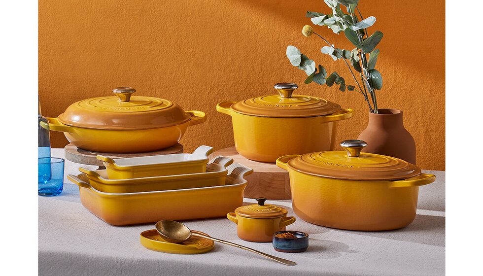 Special Wedding Gift List Ideas for the Kitchen | Set of Yellow Le Creuset Casseroles on a White Table