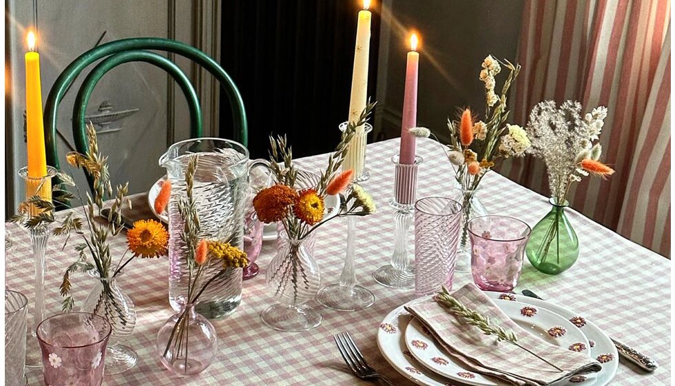 Special Wedding Gift List Ideas for the Dining Room | A Colourful Tablescape Featuring Gingham Table Linen, Tall Candles in Clear Candle Sticks, Autumnal Flowers, and Tableware with Floral Pattern