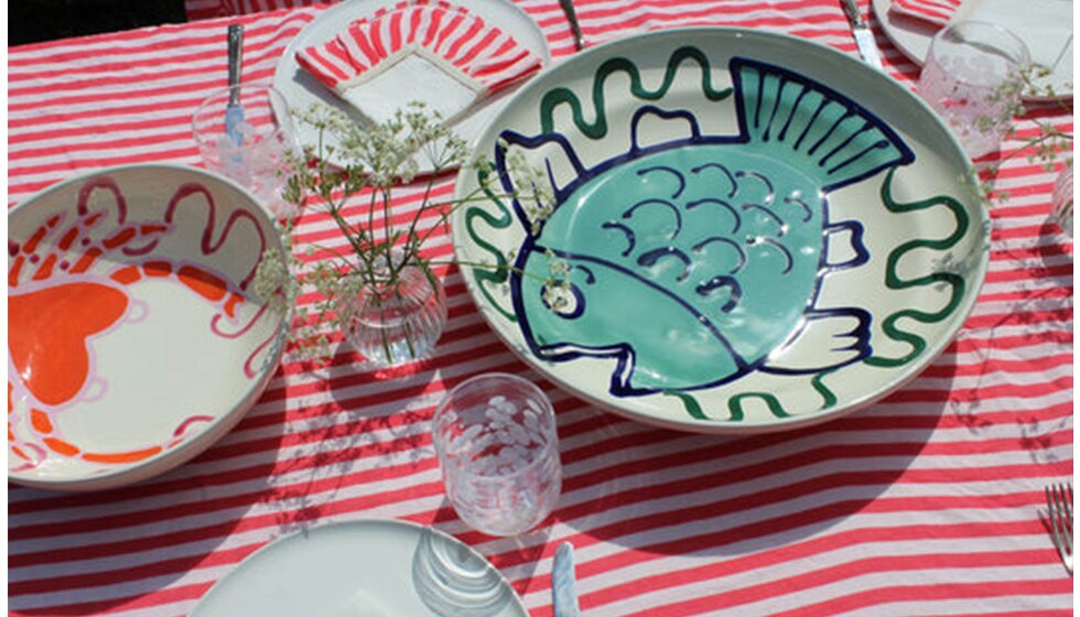 Whimsical Floral Wedding in London Park | A summer tablescape featuring wedding gifts from Amuse La Bouche: red striped tablecloth, fun ceramic bowls with hand-painted fish and crab