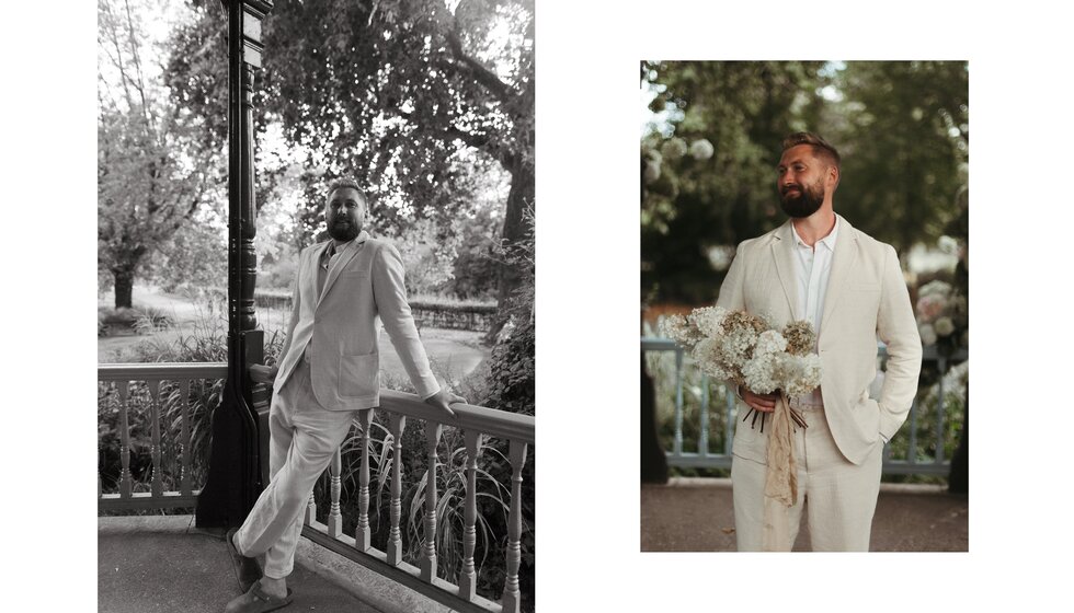Whimsical Floral Wedding in London Park | The groom, wearing a cream linen wedding suit and brown Birkenstock, is posing next to a park bandstand.