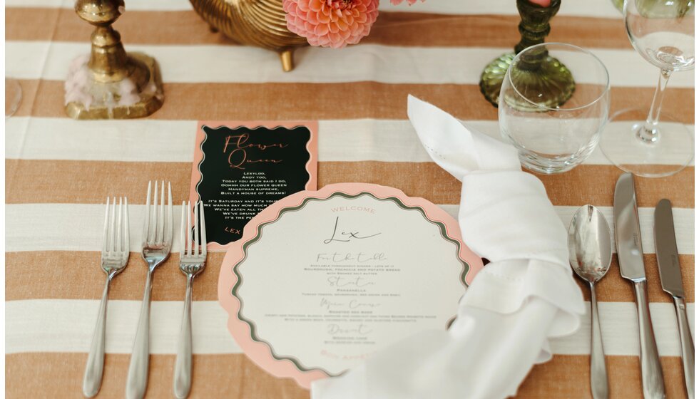 The Ultimate Wedding Planning Checklist | A blush and green wedding stationery and menu with scalloped details set up as part of the relaxed wedding reception tablescape