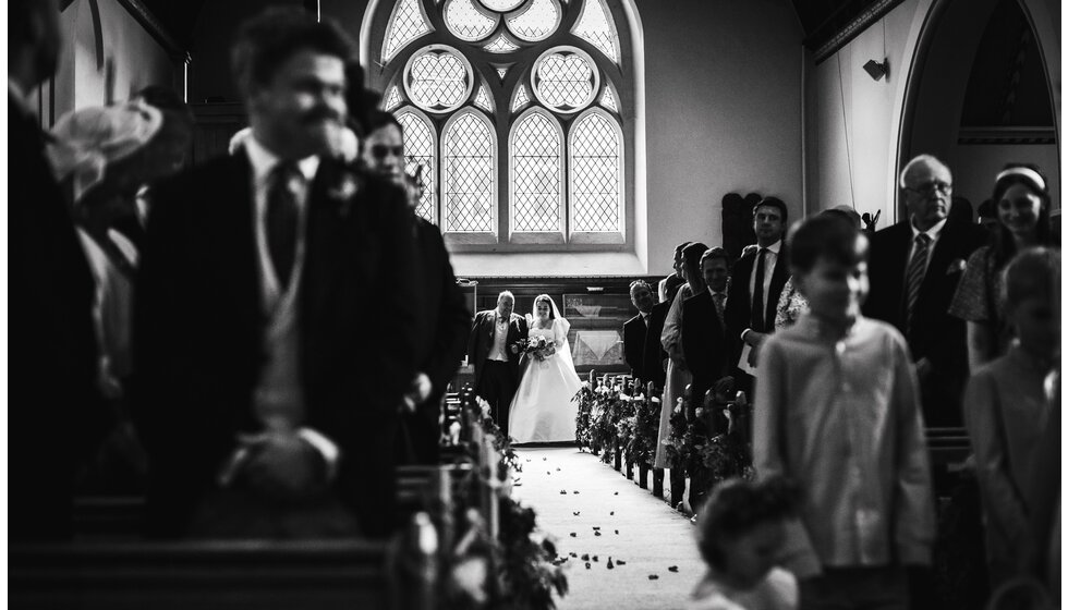 The Wedding Present Company | Bride walking down the aisle of her traditional English church wedding