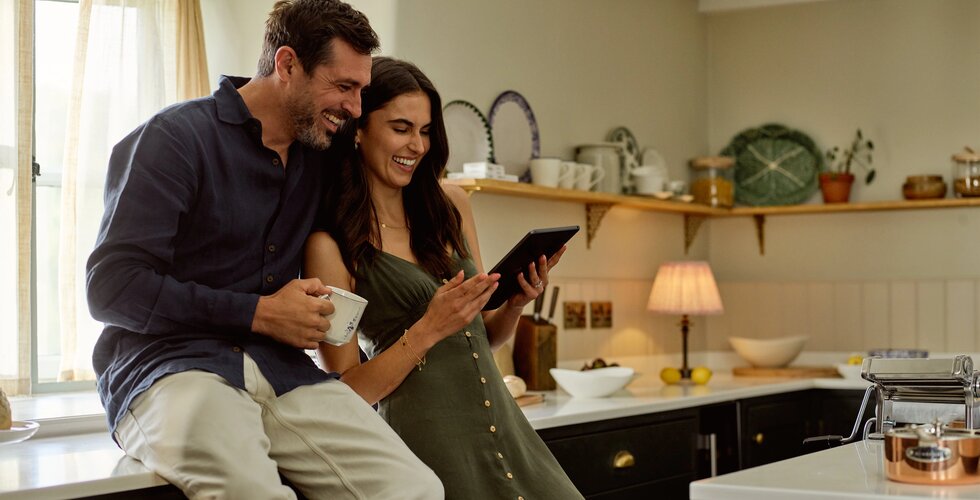 How To Create Your Perfect Wedding Gift List: Happy Couple Curating Their Wedding Registry on Ipad